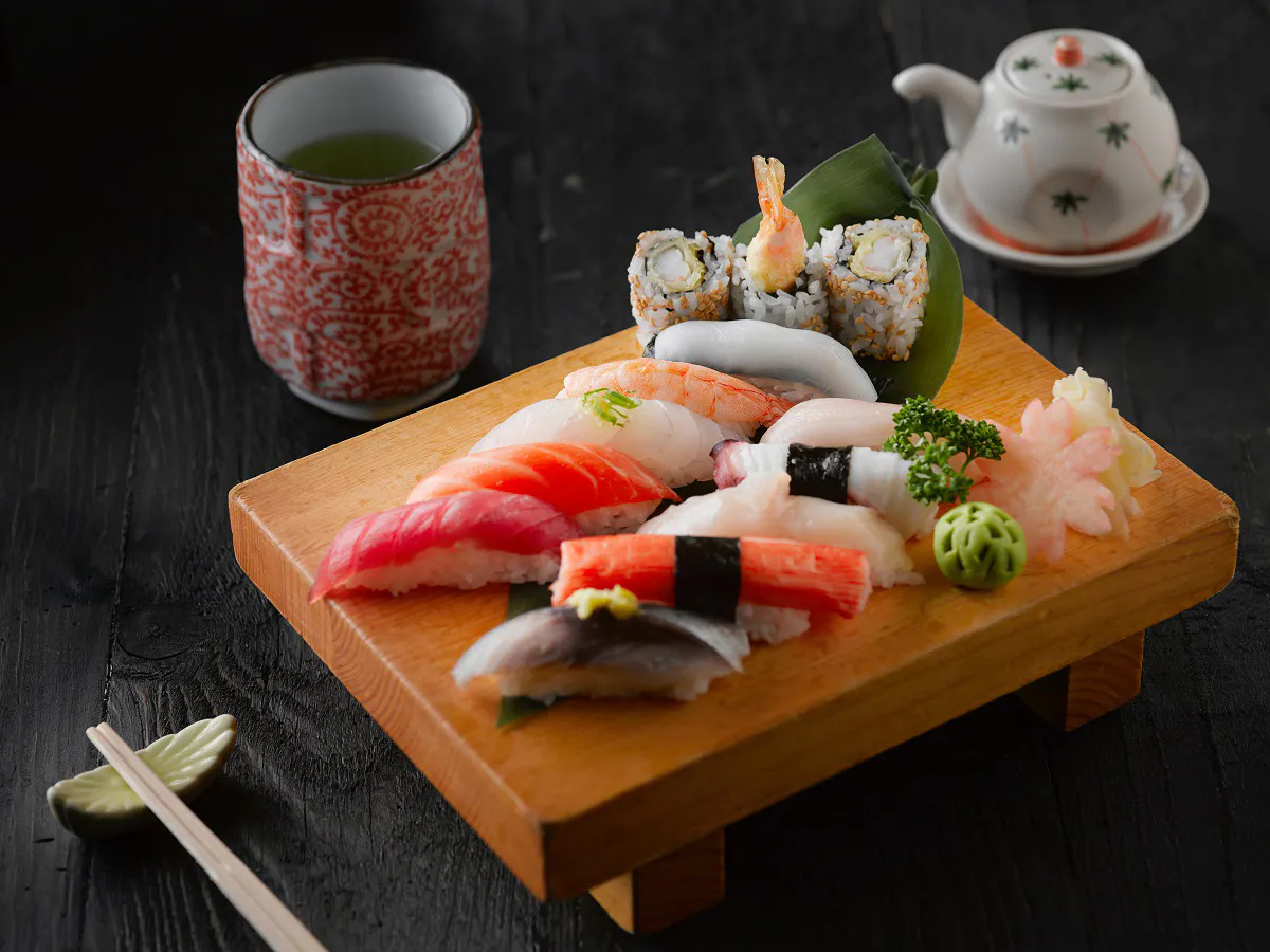 Assorted nigiri sushi platter with green tea and teapot at Hinoki Men, a Japanese Restaurant in Rancho Cucamonga