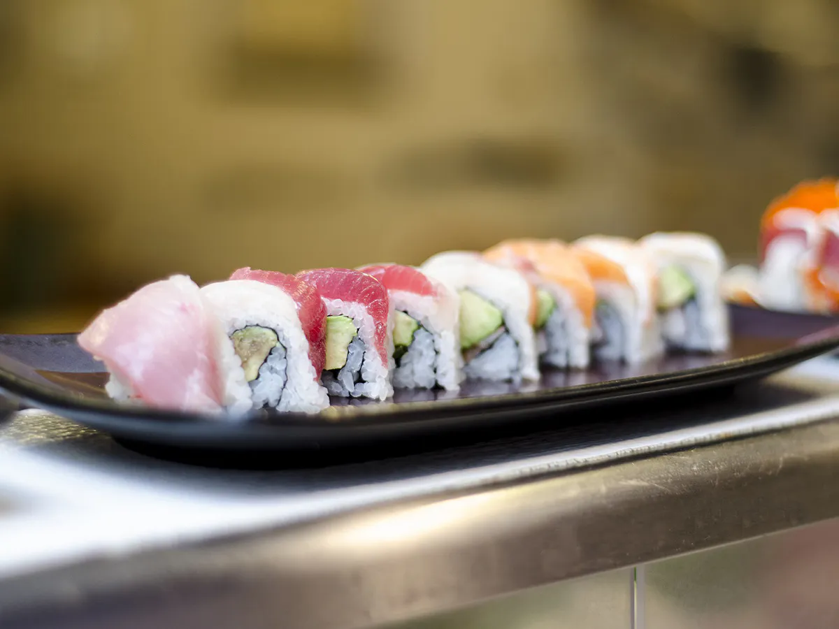 Fresh tuna salmon avocado sushi rolls on dark plate at Hinoki Men, a Japanese Restaurant in Rancho Cucamonga